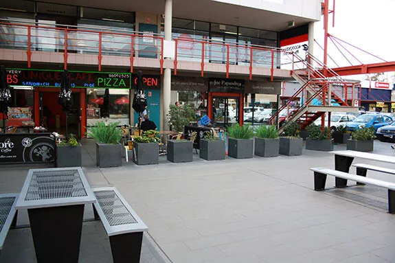 IOTA Granite Planters lined up in front of Pizza Place